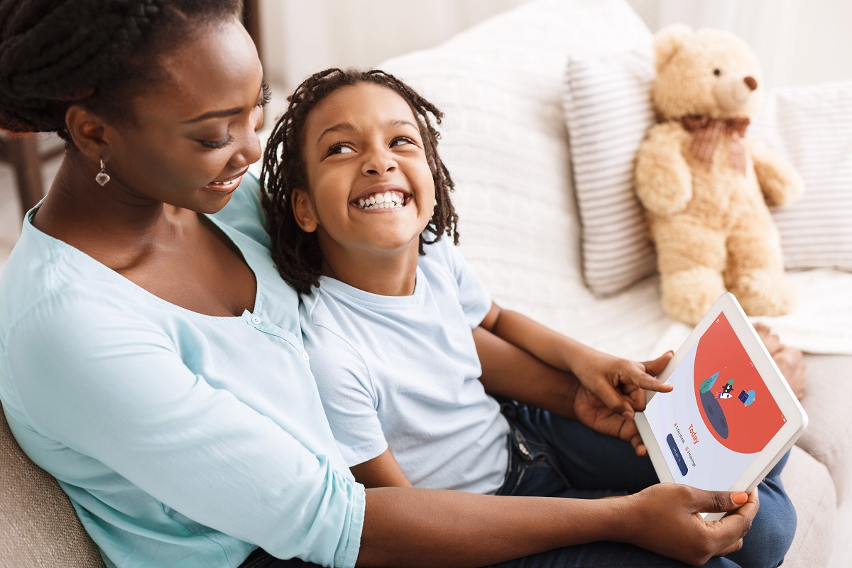 Mother and son working with dyslexia app Mother and son working with dyslexia app